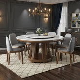 Round wooden dining table with marble top and six matching chairs on a white background