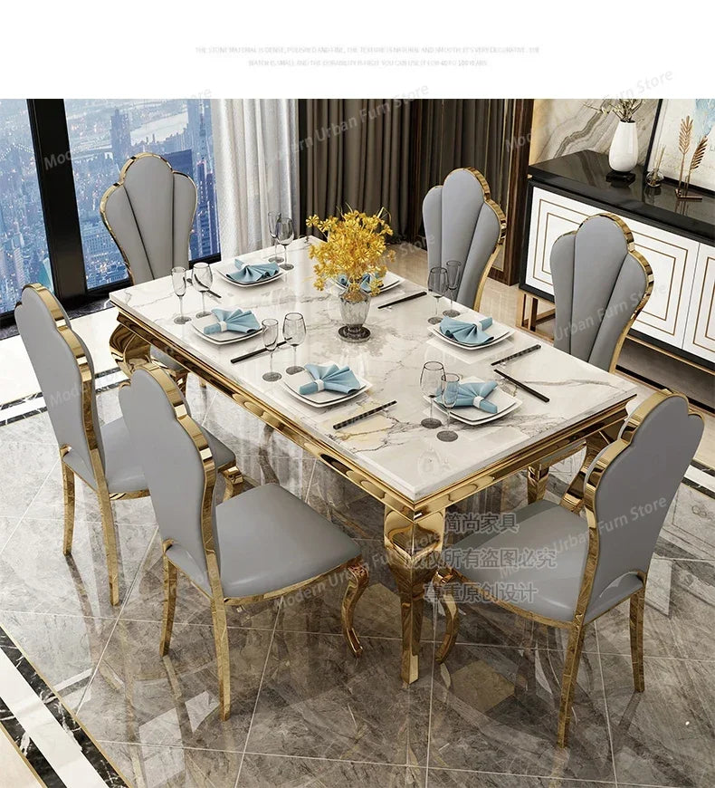 Dining table set with marble top and gold accents in a modern room.