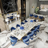 Luxury marble dining table set elegantly arranged with blue chairs in a modern dining room.
