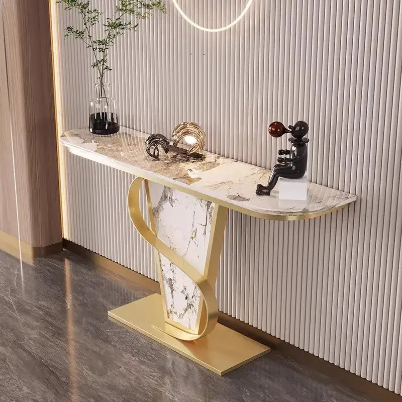 Decorative console table with marble top and gold base against a striped wall.