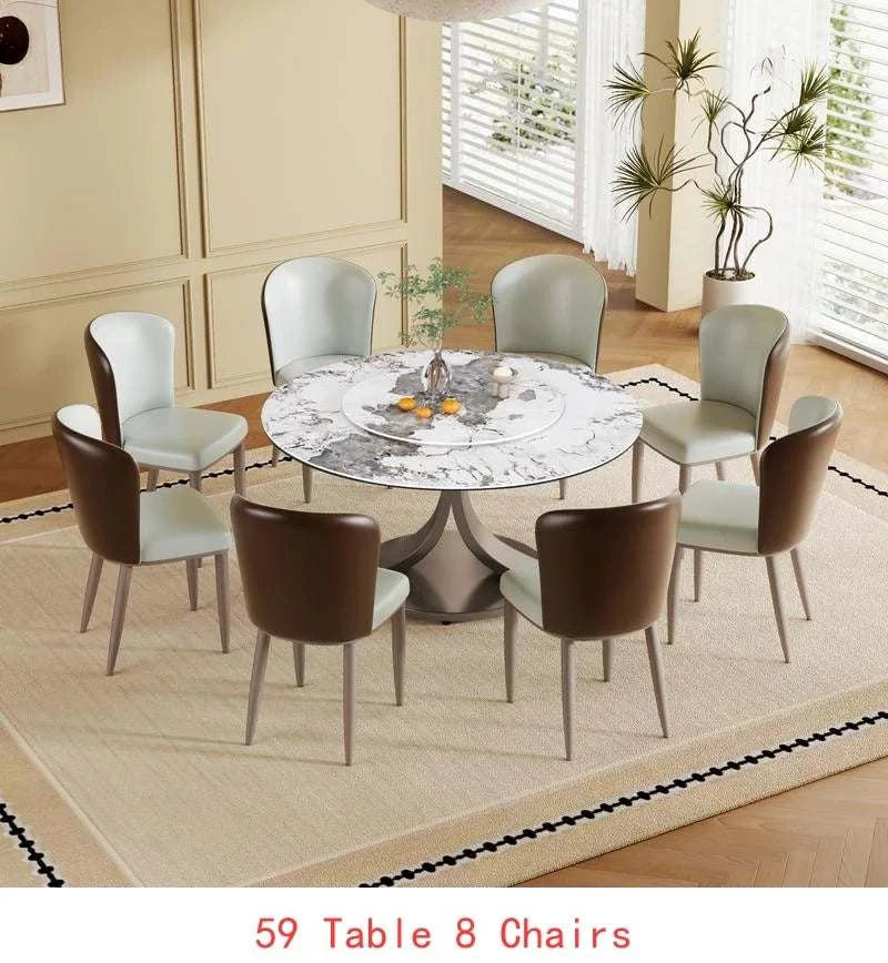 Dining room setup with a round table and eight chairs on a beige rug.