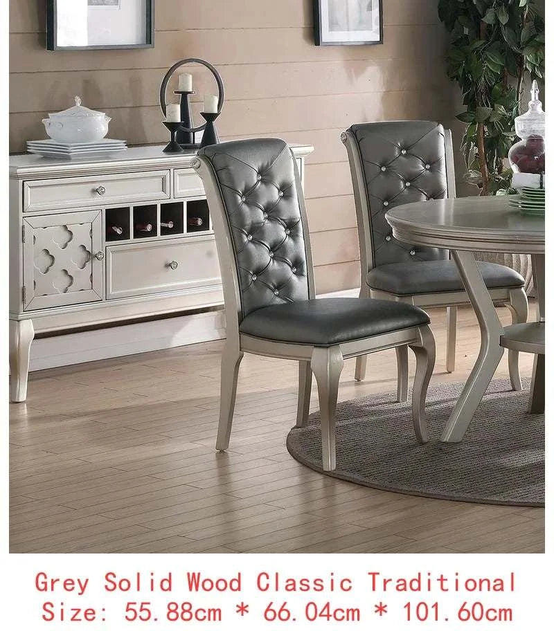 Dining room with gray upholstered chairs and a white sideboard.