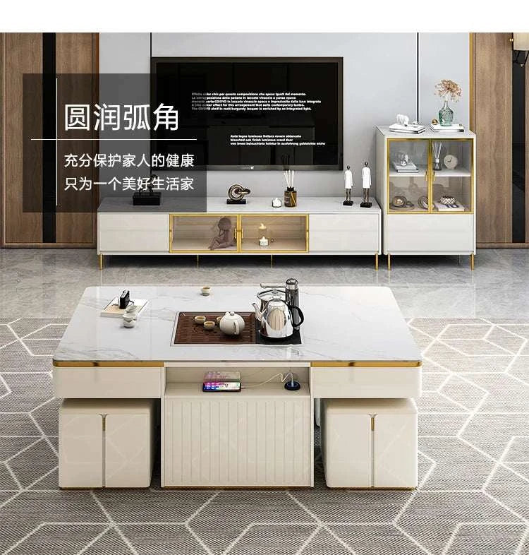 Modern living room with a white entertainment console, coffee table, and decorative items.