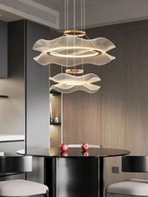 Modern LED ceiling chandelier with wavy design, enhancing a stylish dining space.