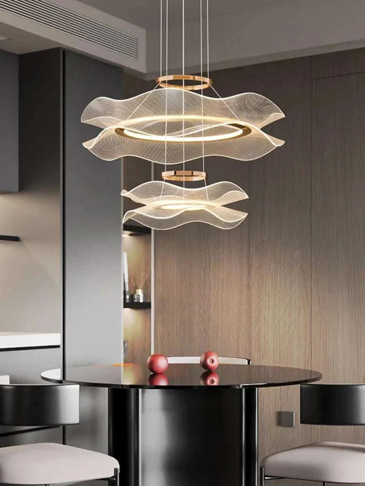 Round modern LED ceiling chandelier with wave design and warm lighting above dining table