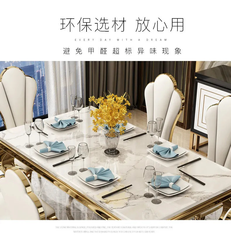 Luxury marble dining table with gold base set for six with elegant table settings and floral centerpieces.
