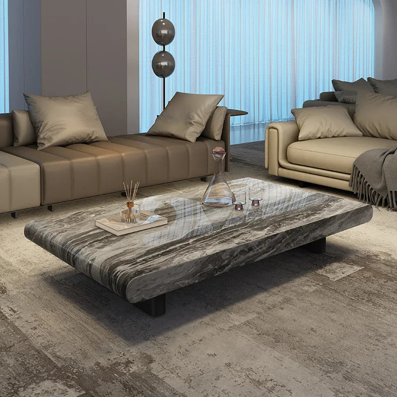 Modern living room with marble coffee table and beige sofas.