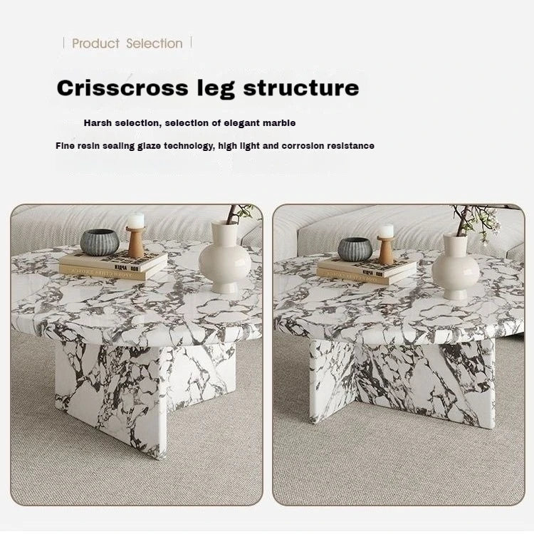 Marble coffee table with crisscross leg structure on a neutral background