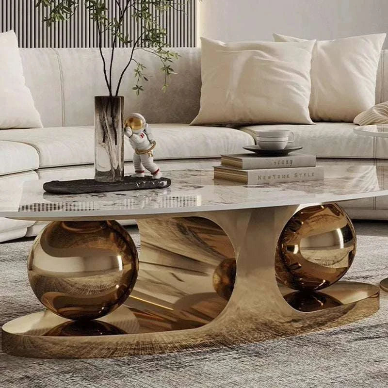 Modern living room with a marble coffee table, decorative items, and a sofa.