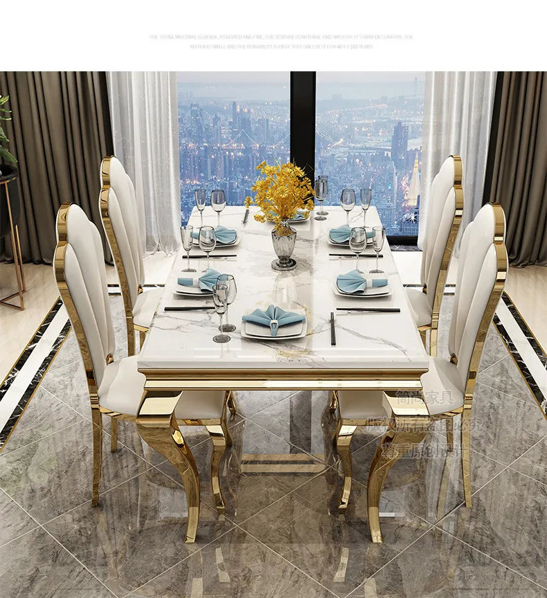 Luxury marble dining table with gold base, seats 6, elegantly styled with white chairs and stunning city view.