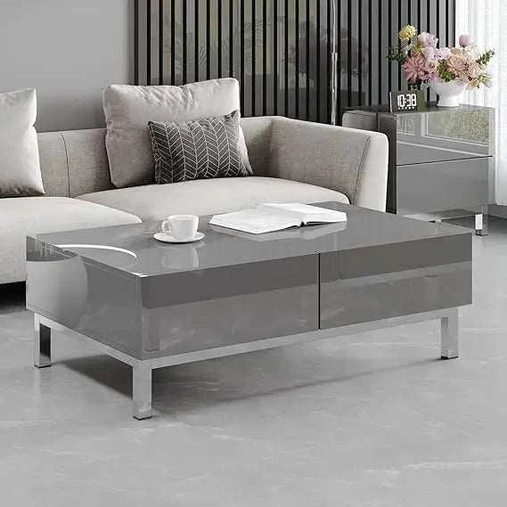 Gray high-gloss coffee table in front of a gray sofa with decorative pillows in a modern living room.