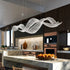 modern French crystal chandelier in a stylish kitchen over a marble island table.