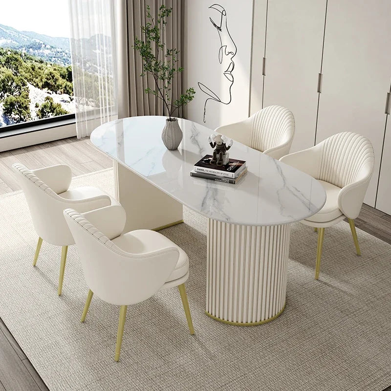 Modern dining room with marble table and chairs near a window with a view of a scenic landscape.