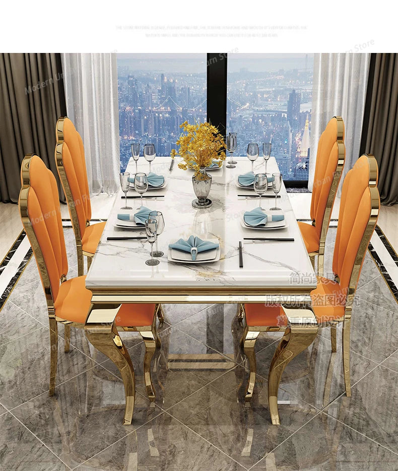 Dining table set with orange chairs and a cityscape view in the background