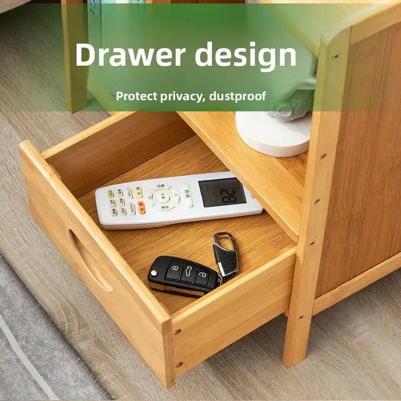 Wooden drawer with a remote control and keys, labeled &