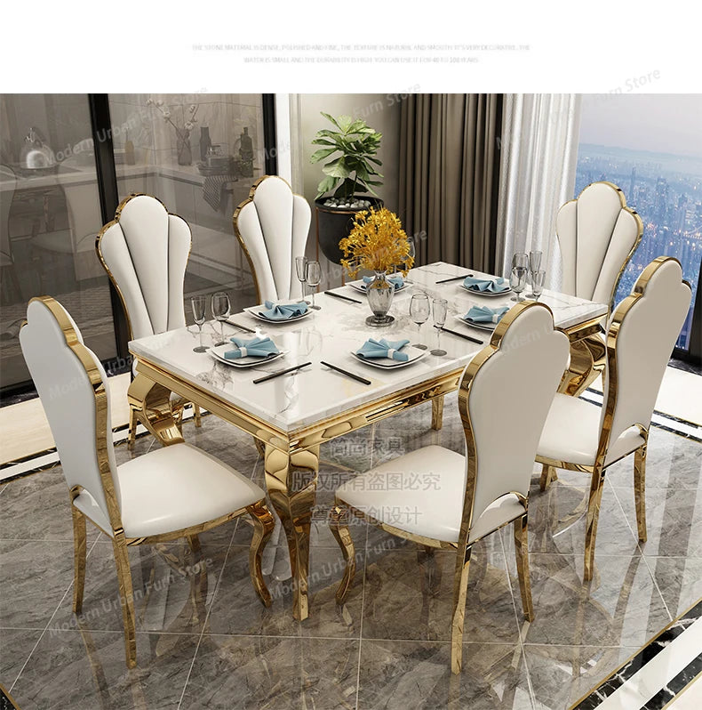 Dining table set with marble top and gold legs in a modern interior setting.