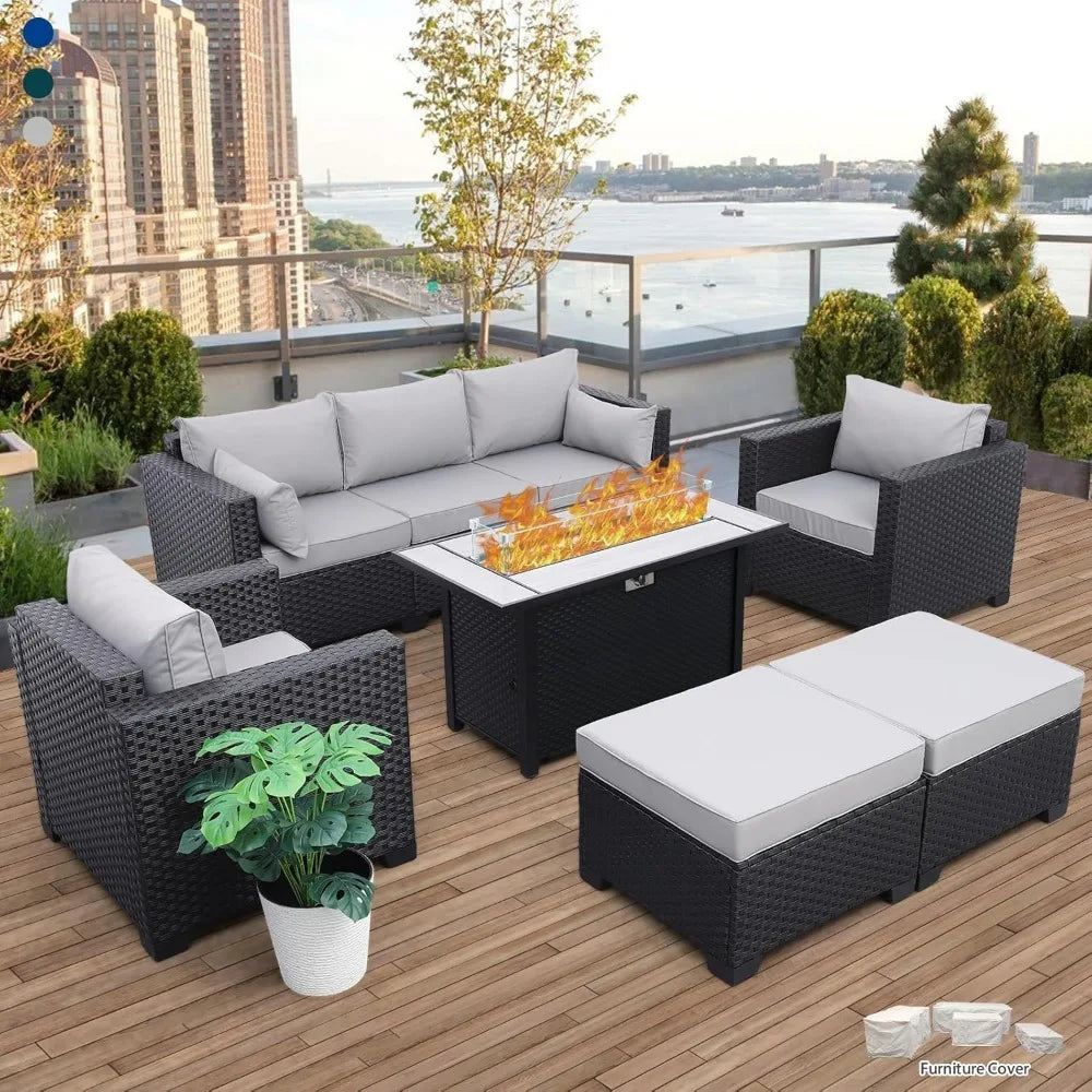 Outdoor patio furniture set with fire pit table on a wooden deck with cityscape background