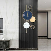 Large gold metal wall clock with modern design on a stylish wall in a contemporary room