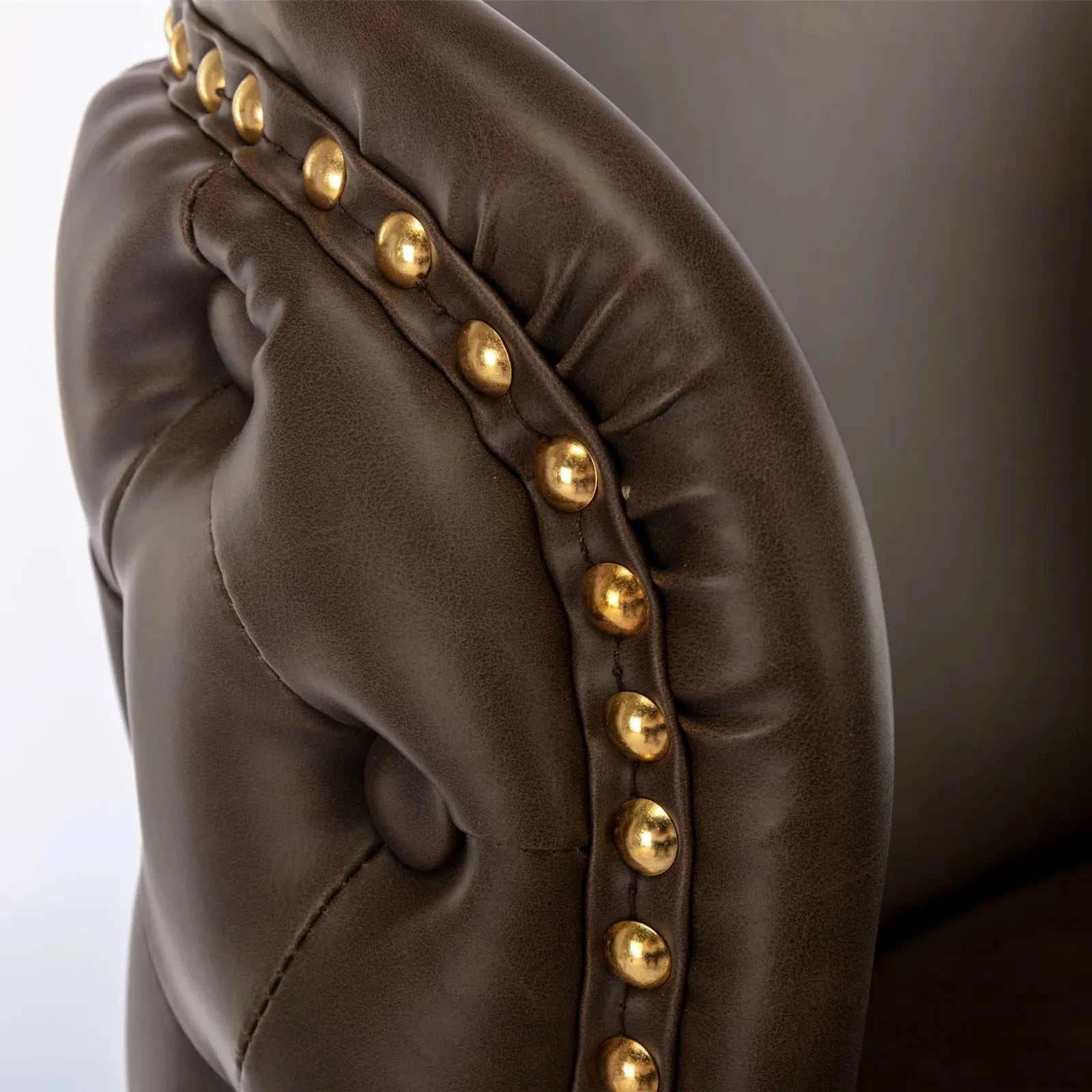 Brown leather glove with gold studs on a white background