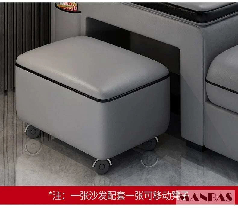 Gray ottoman with wheels next to a gray sofa in a room.