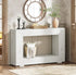 White wooden console table with decorative items in a room setting.