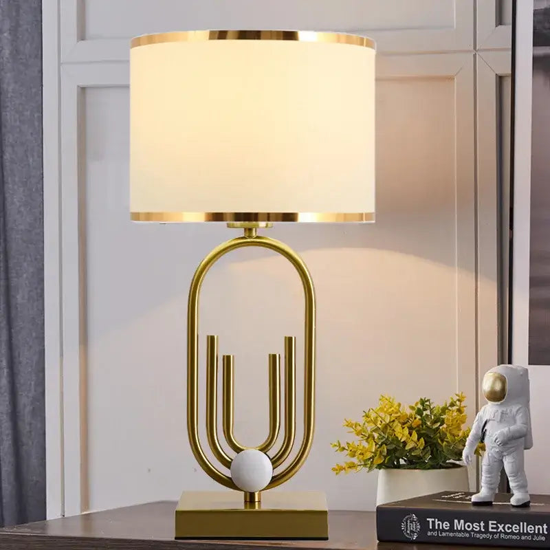 Nordic luxury bedside lamp featuring a gold base and warm white shade, perfect for elegant bedroom decor.