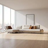 Modern white sofa with decorative pillows on a plain background