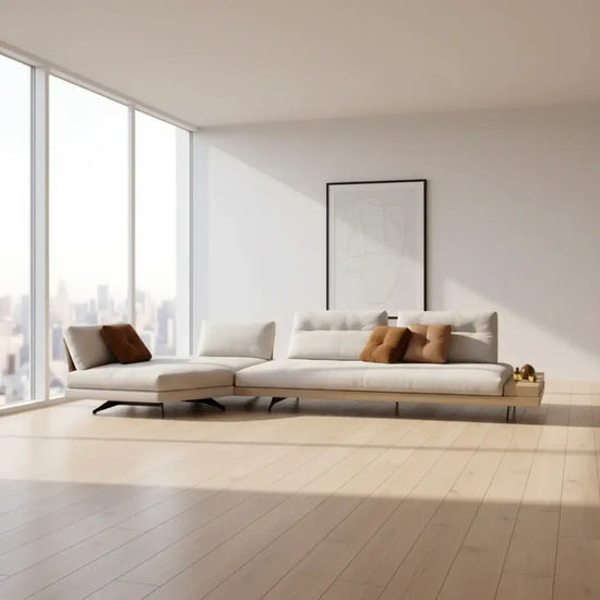 Modern white sofa with decorative pillows on a plain background