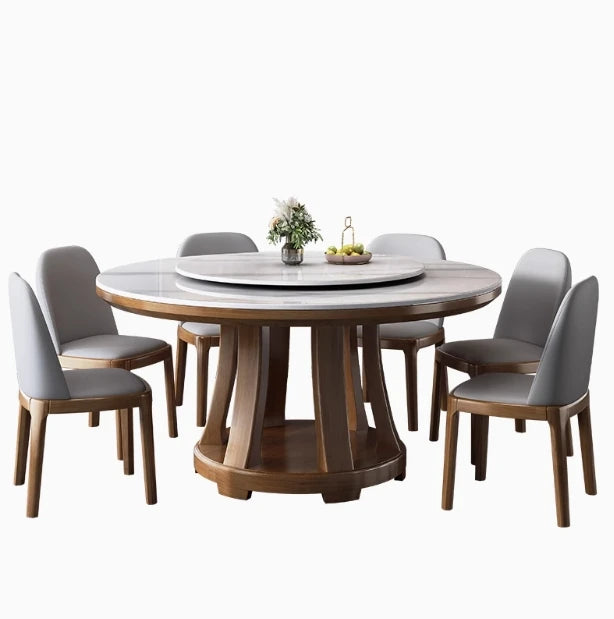 Round wooden dining table with six gray chairs on a white background