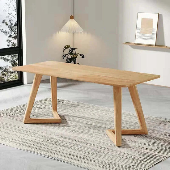 Wooden dining table in a modern room with a rug and plant