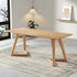 Wooden dining table in a modern room with a rug and plant