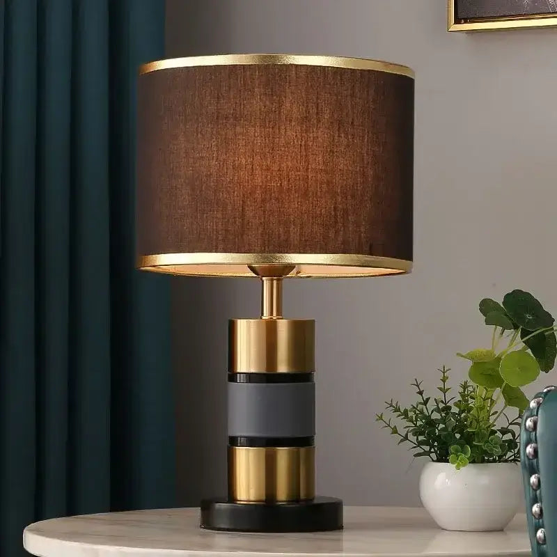 Luxury LED bedside lamp with gold iron frame and fabric shade on a table in a modern home setting.