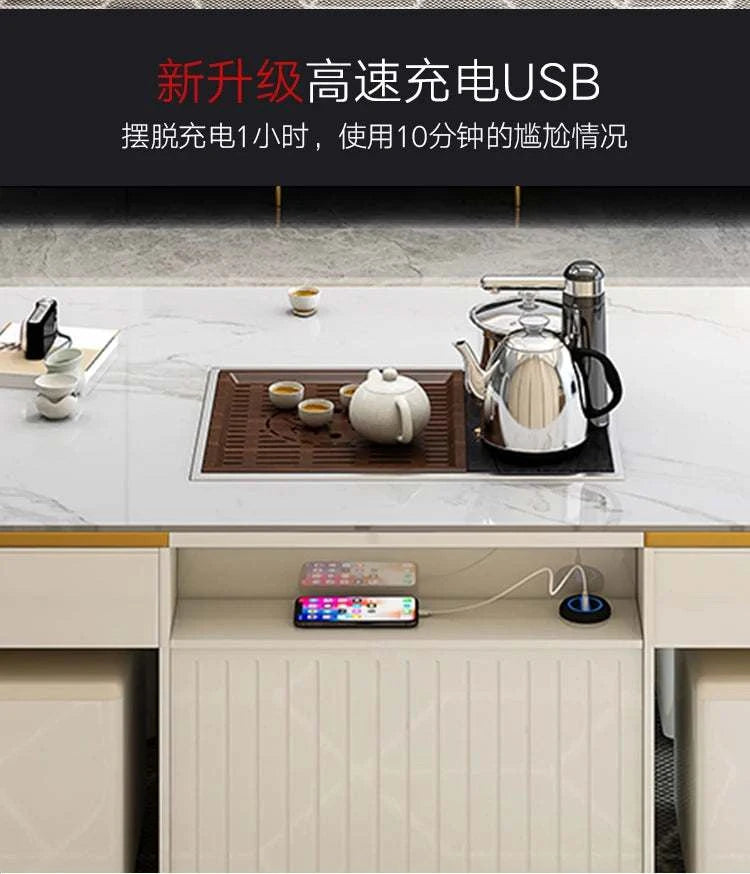 Tea set on a kitchen counter with a phone and kettle, featuring USB charging text.