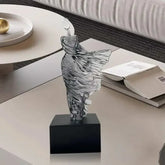 Abstract character resin sculpture with Nordic-inspired smooth contours on black base for modern decor