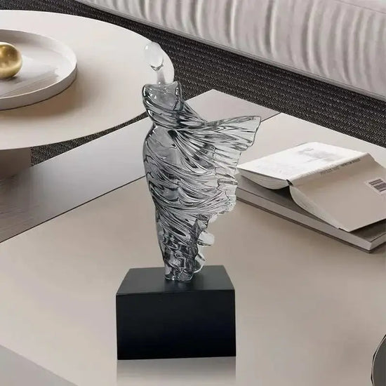 Abstract character resin sculpture with Nordic-inspired smooth contours on black base for modern decor