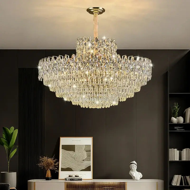 Luxurious chandelier hanging in a room with a dark wall and decorative items.