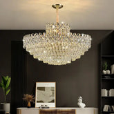 Luxurious chandelier hanging in a room with a dark wall and decorative items.