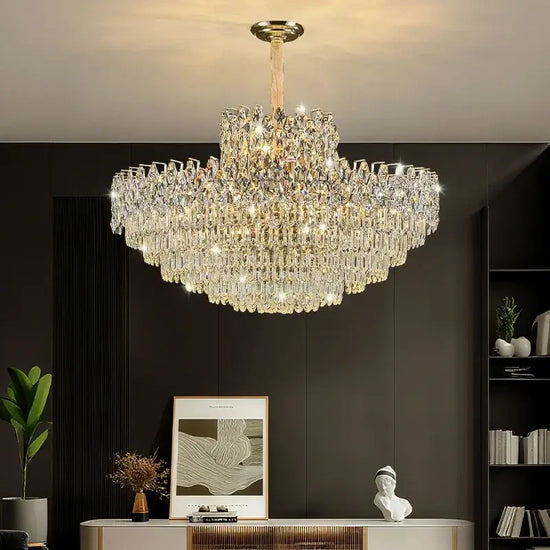 Luxurious chandelier hanging in a room with a dark wall and decorative items.