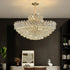 Luxurious chandelier hanging in a room with a dark wall and decorative items.