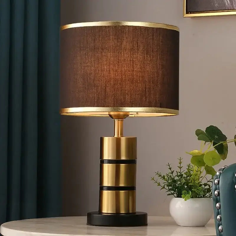 Luxury LED bedside lamp displayed on a table with a modern design and brass accents.
