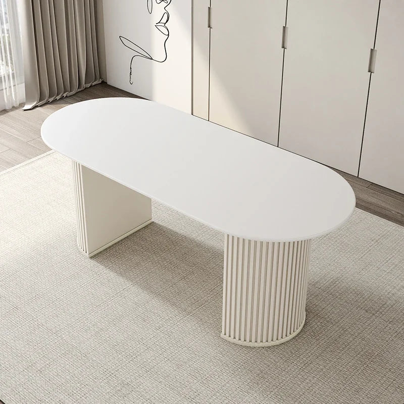 Modern white dining table with cylindrical base in a room setting