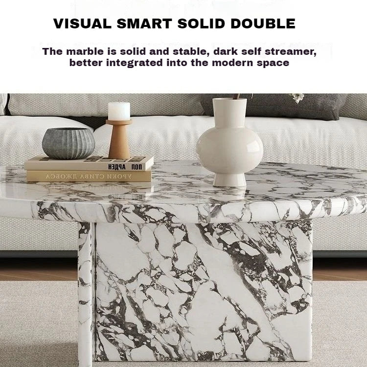 Marble coffee table with decorative items in a living room setting