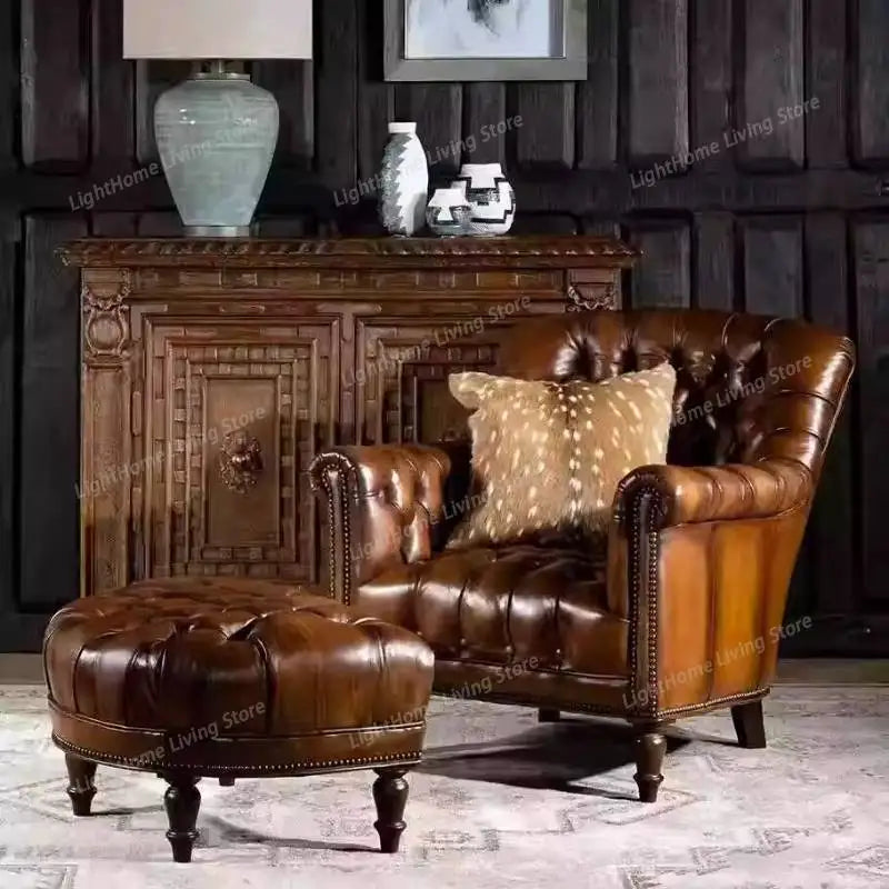 Brown leather armchair and ottoman with decorative items in the background