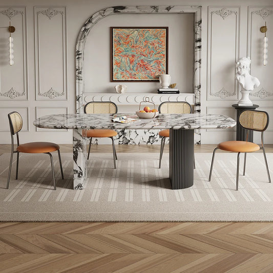 Dining room with marble table and chairs in a stylishly decorated room.