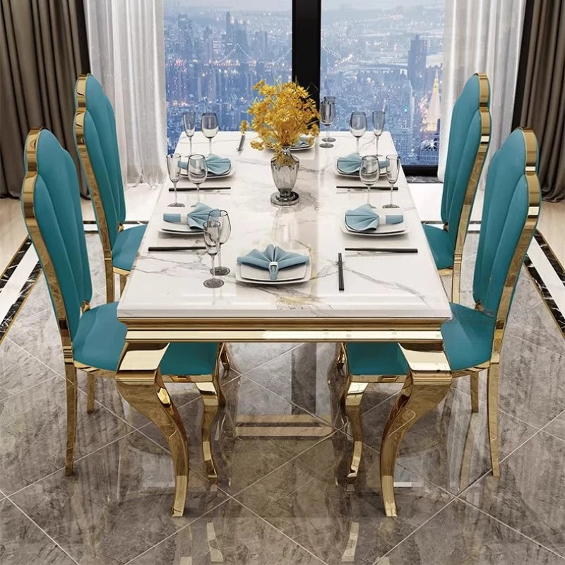 Luxury marble dining table with gold base set for six in an elegant dining room with a city view.