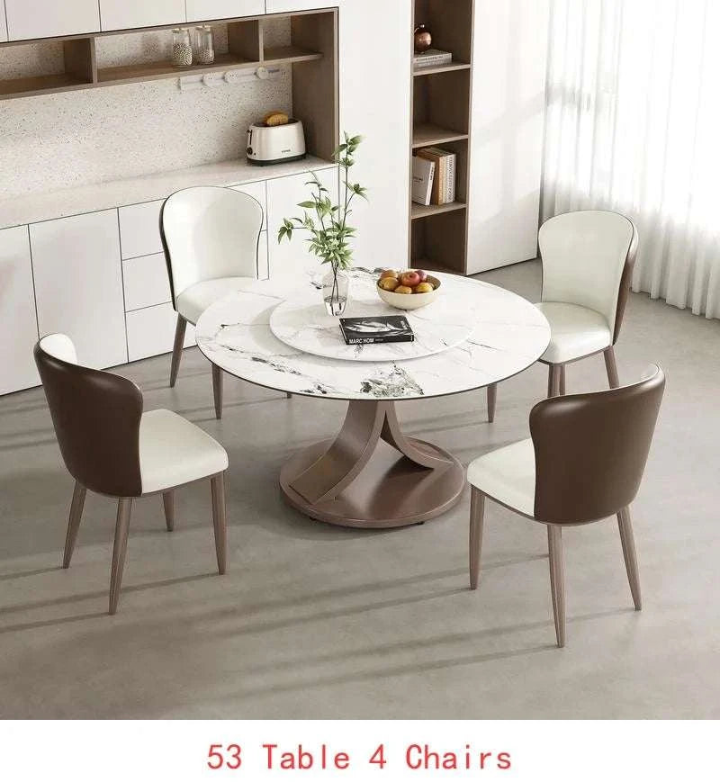 Round dining table with four chairs in a modern kitchen setting