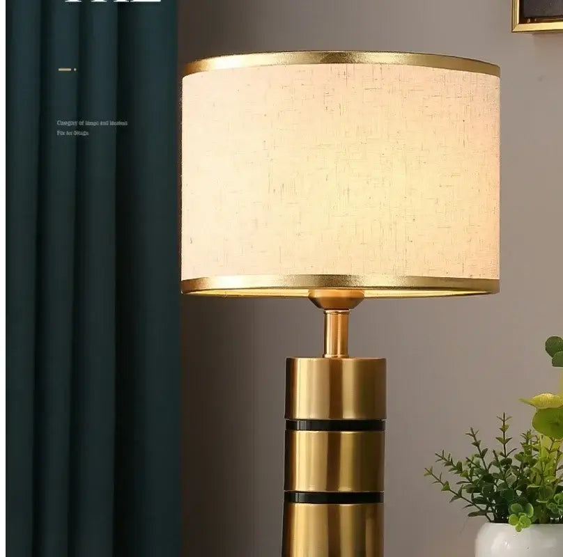 Luxury LED bedside lamp with a gold frame and fabric shade in a stylish home setting.