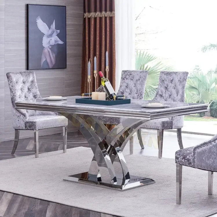 Dining room with a modern stainless steel table and gray chairs.