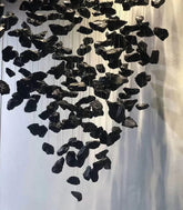 Black stone-like decorative hanging pieces on a white background