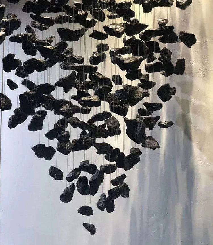 Black stone-like decorative hanging pieces on a white background